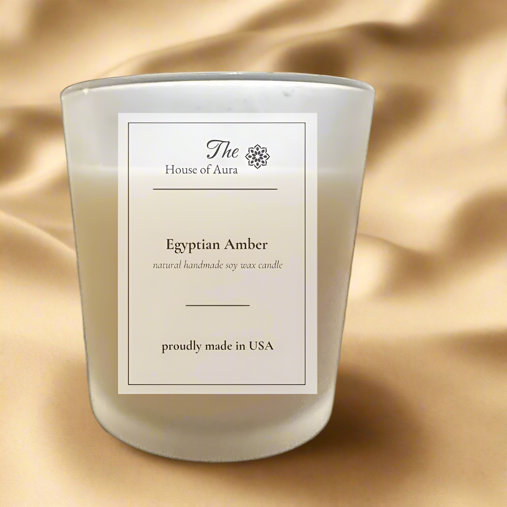 Egyptian Amber scented soy wax candle in clear glass jar with wooden lid, showcasing warm amber and exotic spice fragrance.